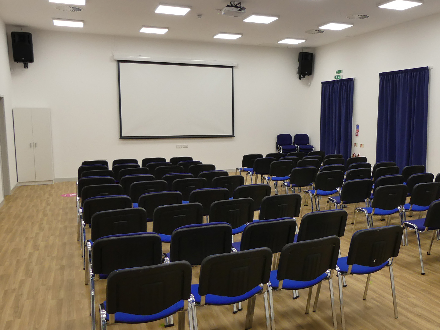 Projector and screen in village hall installation